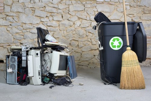 Recycling bins and general waste in a workplace environment